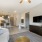 pacious well lit living room with wood floors and large windows 