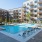 Large sparkling blue pool with a large pool deck and lounge chairs