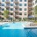 Large sparkling blue pool with a large pool deck and lounge chairs